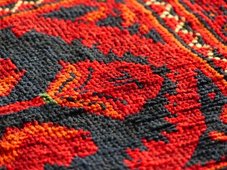 red-orange carpet swatch of printed carpet
